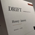 Macro close-up of soft-touch matte finish texture on DRIFT tea box surface